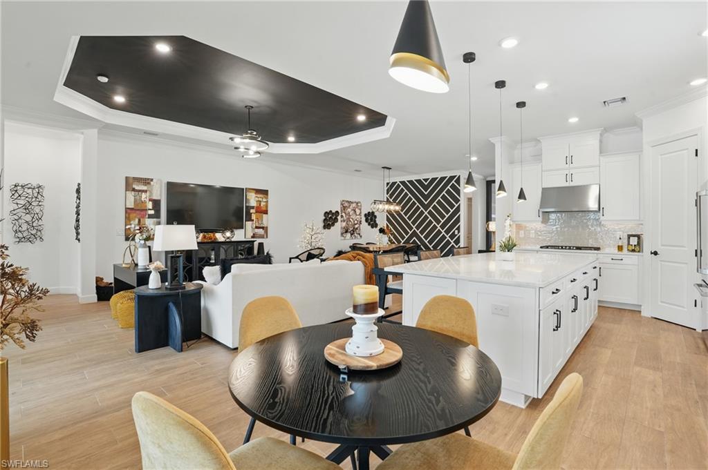 17467 Caravita Lane Fort Myers, FL 33913 - Photo 15 of 50 a living room with fireplace furniture and a dining table