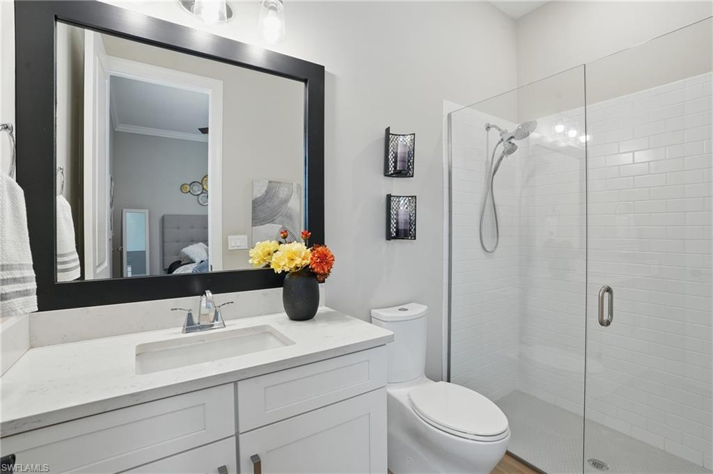17467 Caravita Lane Fort Myers, FL 33913 - Photo 26 of 50 a bathroom with a sink toilet and shower