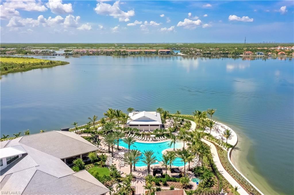 17467 Caravita Lane Fort Myers, FL 33913 - Photo 43 of 50 a view of a lake and a building in the background