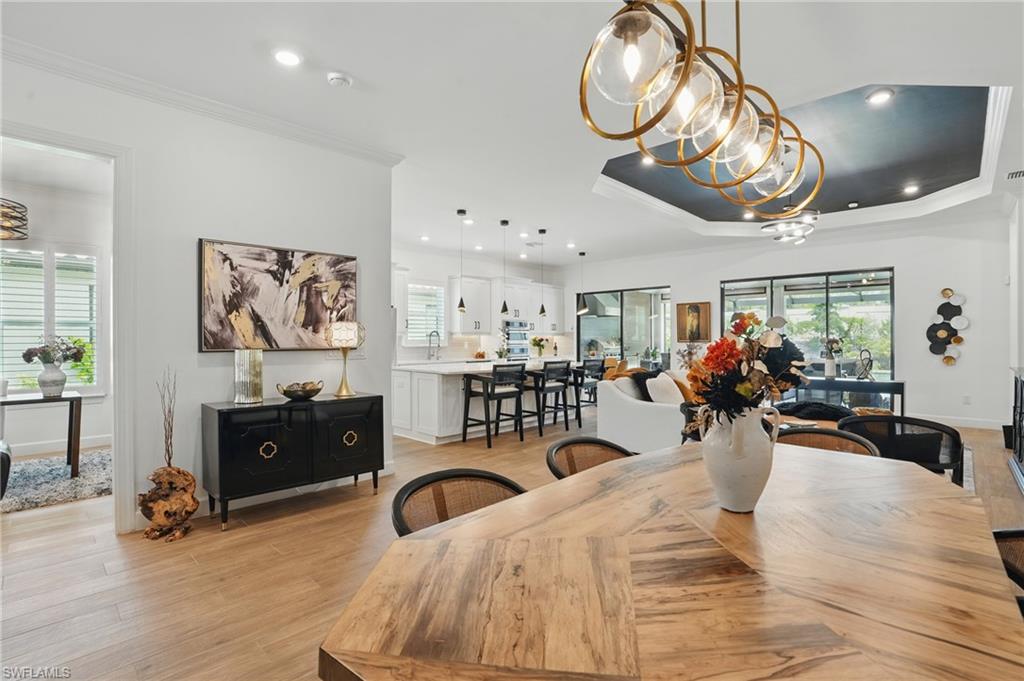 17467 Caravita Lane Fort Myers, FL 33913 - Photo 6 of 50 a bedroom with furniture a chandelier and a large window