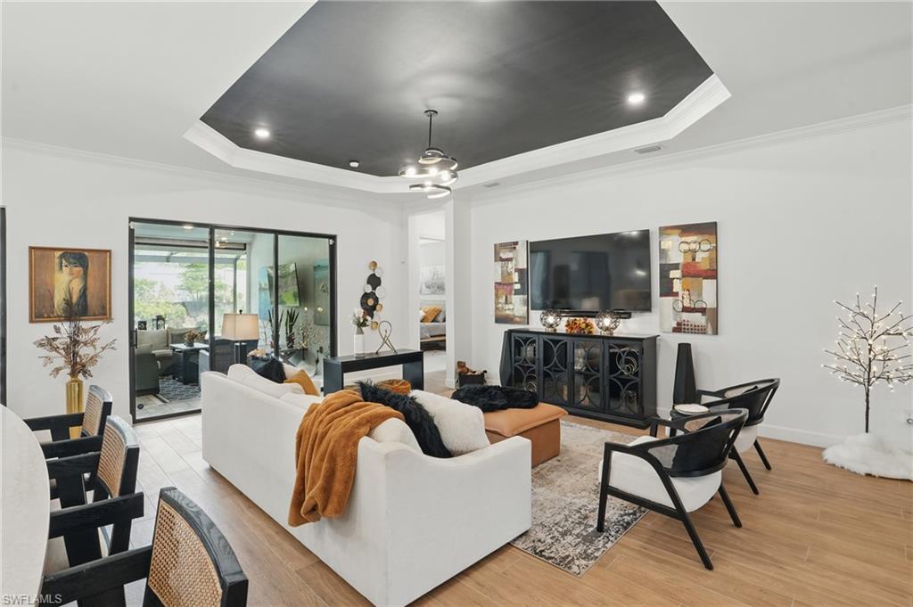 17467 Caravita Lane Fort Myers, FL 33913 - Photo 9 of 50 a living room with furniture and a flat screen tv