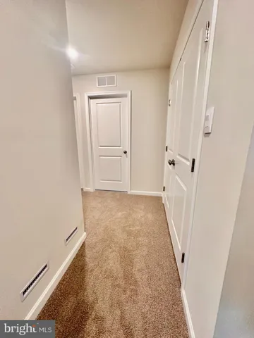 a view of a hallway with white walls