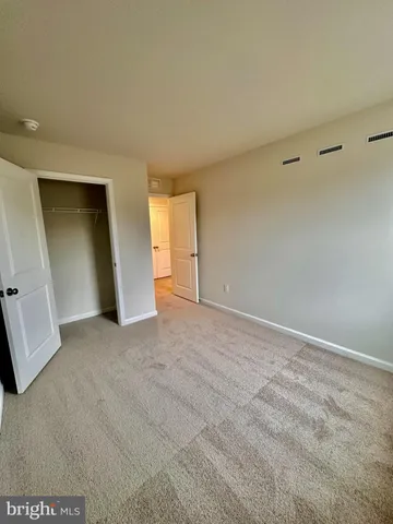 a view of an empty room and closet area