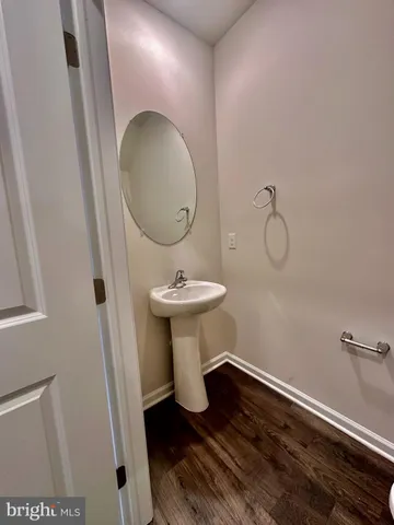 a bathroom with a sink toilet and mirror