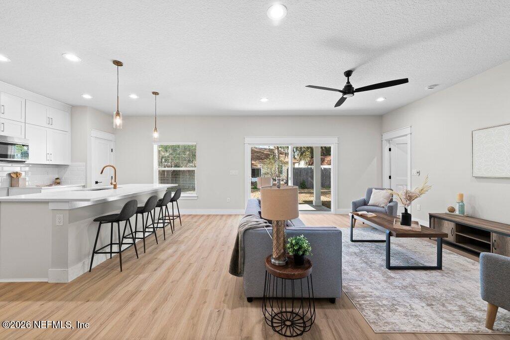 9019 Hipps Road Jacksonville, FL 32222 - Photo 26 of 35 Living Room/ Kitchen
