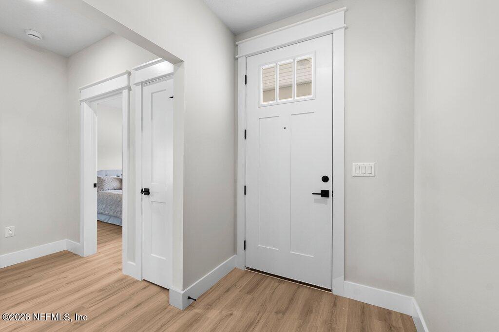 9019 Hipps Road Jacksonville, FL 32222 - Photo 6 of 35 a view of a hallway with wooden floor