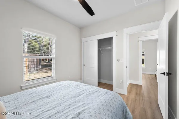 a spacious bedroom with a bed and a chandelier