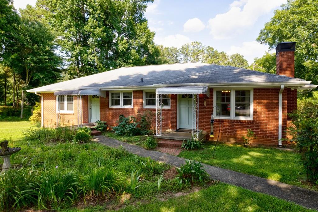 14735 Freemanville Road Milton, GA 30004 - Photo 1 of 1 a view of a house with a yard and plants