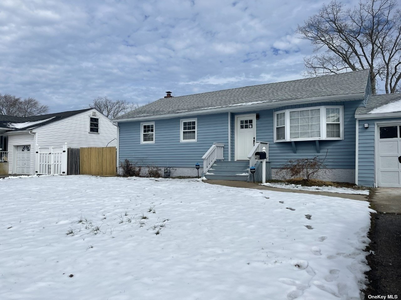 36 Jay Road Centereach, NY 11720 - Photo 1 of 1 a front view of house with yard and trees in the background