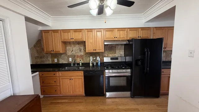 a kitchen with granite countertop a refrigerator and a stove
