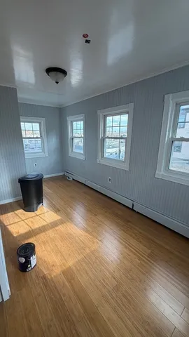 a view of a room with window and wooden floor