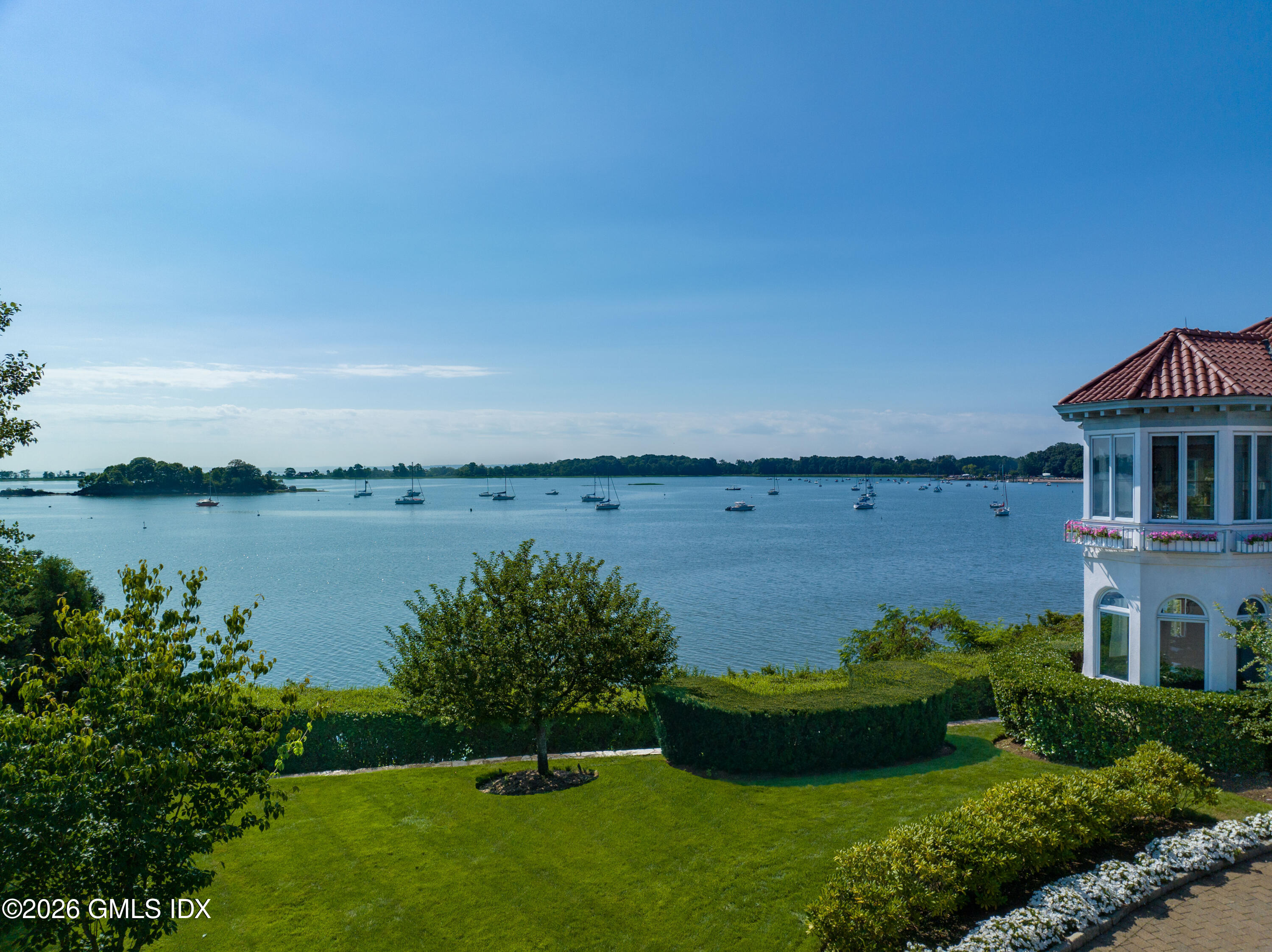 108 Cedar Cliff Road Riverside, CT 06878 - Photo 10 of 49 a view of a house with a garden and lake view