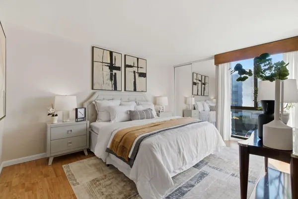 a bed room with a bed and a painting on the wall