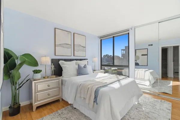 a bedroom with furniture and a potted plant