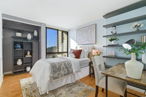 a bedroom with a bed and wooden floor