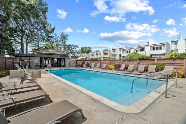 a view of a swimming pool with outdoor seating