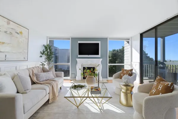 a living room with furniture a fireplace and a flat screen tv