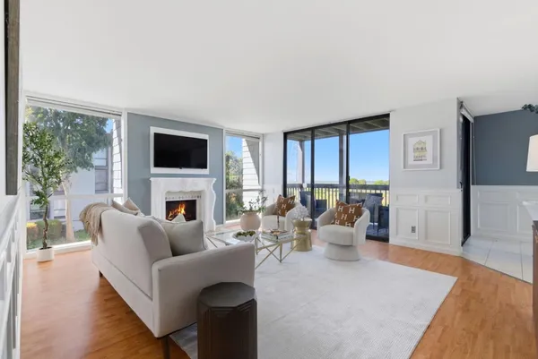 a living room with furniture a fireplace and a flat screen tv