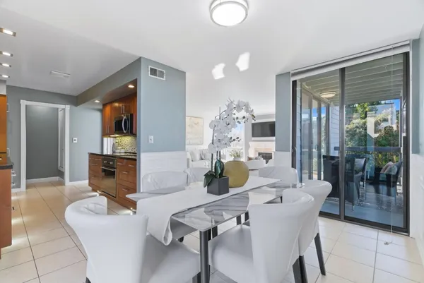 a view of a dining room with furniture and chandelier