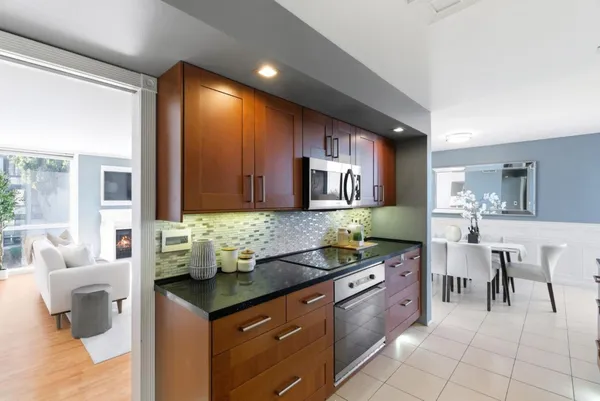 a kitchen with granite countertop a sink and cabinets