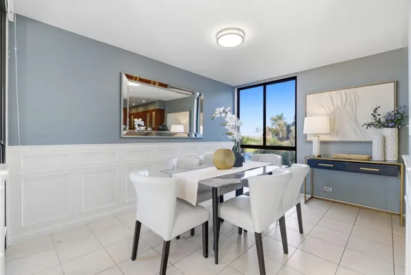a dining room with furniture and window