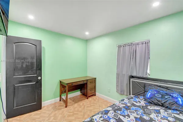 a bedroom with a bed and a dresser
