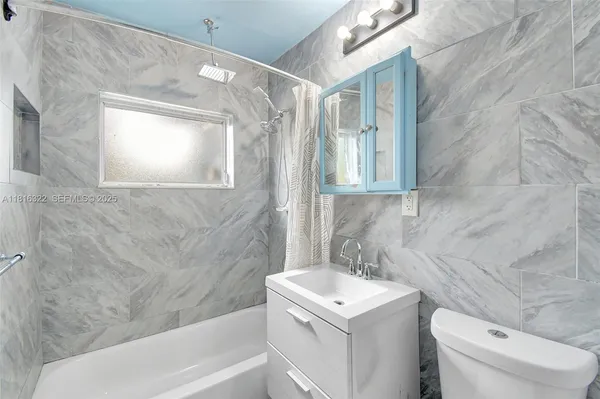 a bathroom with a sink a toilet and a bathtub
