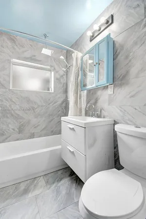 a bathroom with a sink a toilet and bathtub