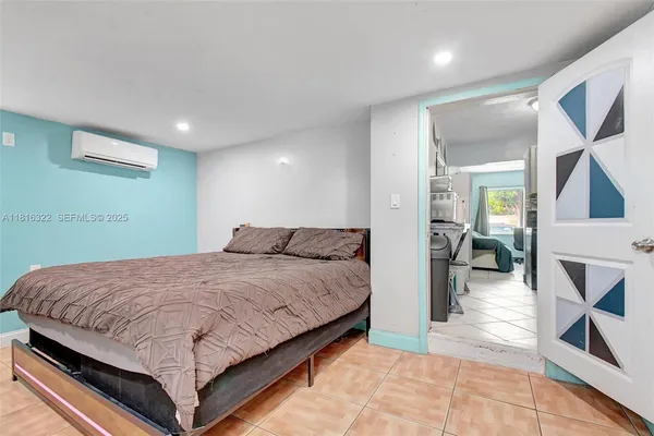 a spacious bedroom with a bed and a rug