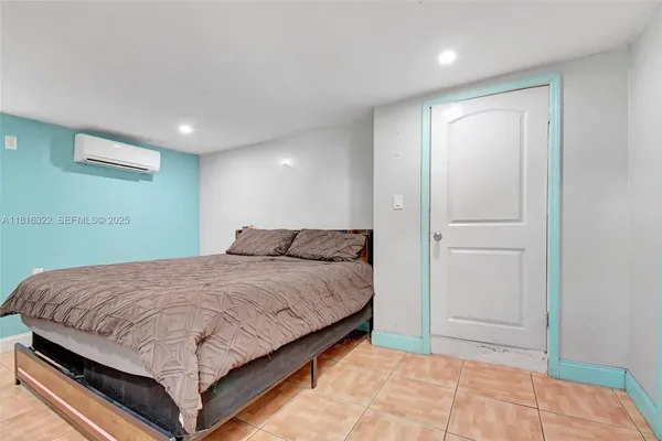 a bedroom with a bed and a painting on the wall
