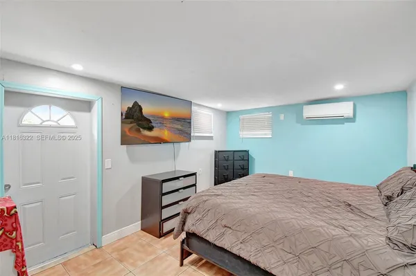 a bedroom with a bed and cabinet