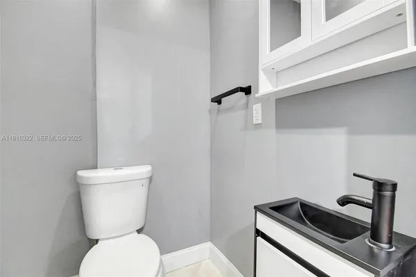 a bathroom with a toilet a sink and a mirror