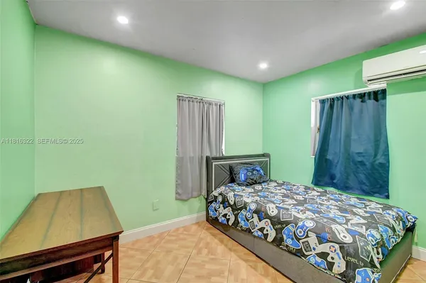 a bedroom with a bed and a chair