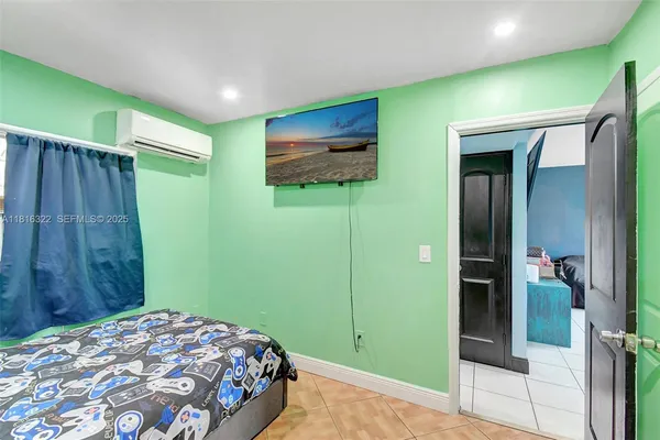 a bedroom with a bed and a mirror