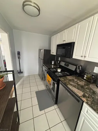 a kitchen with a sink a stove and a microwave