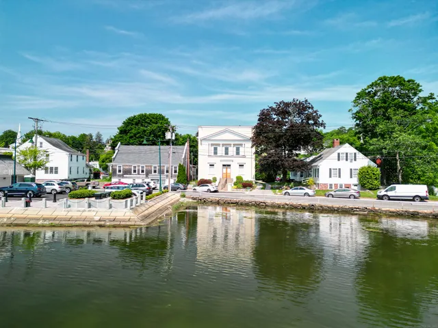 a view of swimming pool with outdoor seating and lake view