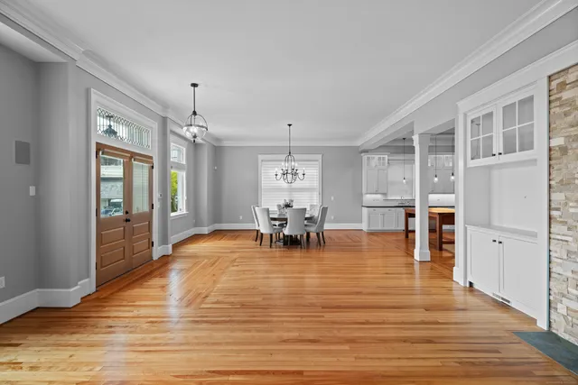 a room with lots of table chair and a view of living room