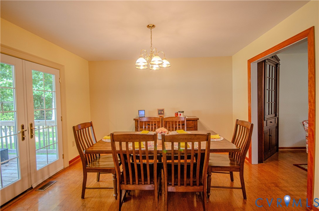 12500 Musical Lane Midlothian, VA 23113 - Photo 17 of 51 Dining area featuring hardwood flooring, a brass-t