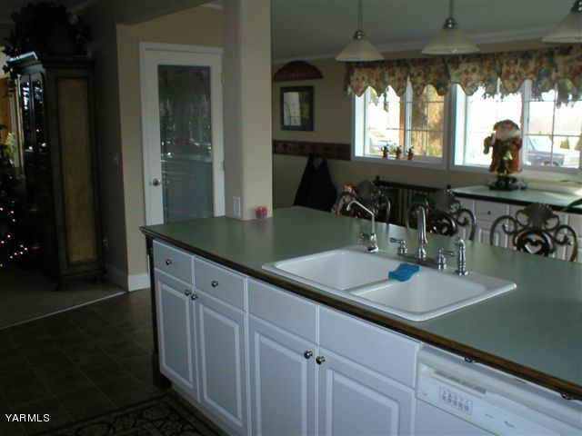 211 Sharp Road Tieton, WA 98947 - Photo 4 of 14 a kitchen with a sink and cabinets