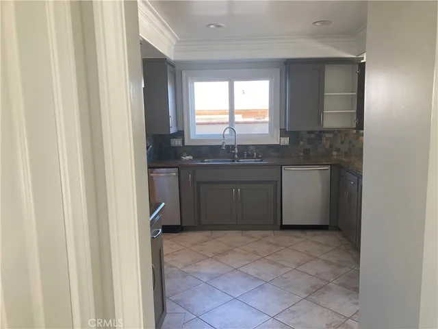 a bathroom with a granite countertop sink a toilet and a bathtub