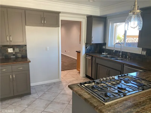 a kitchen with a sink and a stove