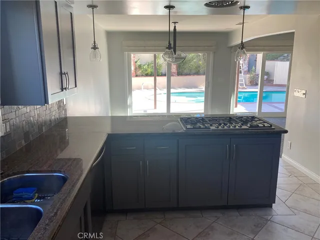 a kitchen with a sink and a large window