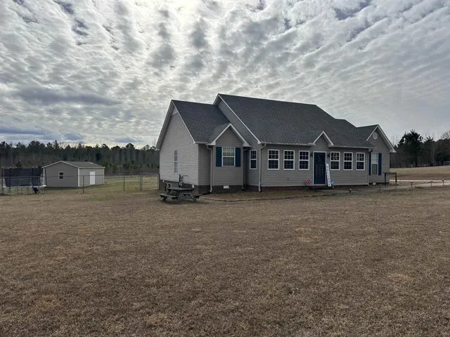 a view of a house with a yard and roof