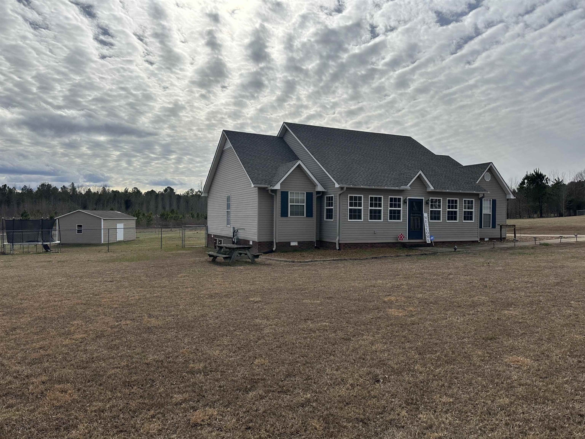 a view of a house with a yard and roof