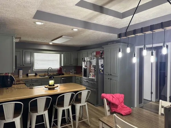 a kitchen with a sink and refrigerator