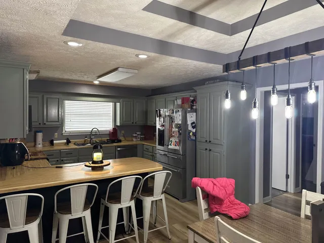 a kitchen with a sink and refrigerator