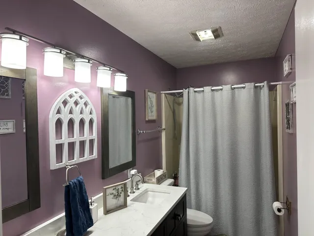 a bathroom with a mirror a sink and a mirror