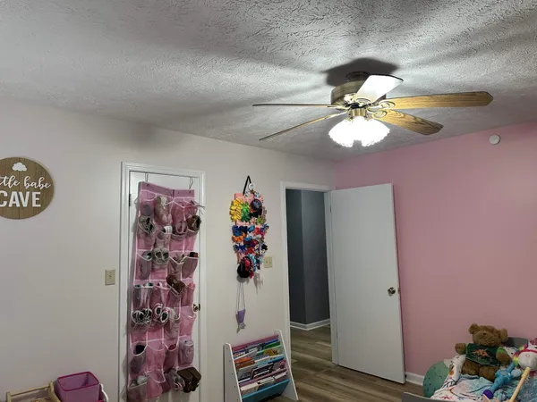 a view of a workspace with furniture and chandelier fan