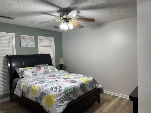 a bedroom with a bed and a chandelier