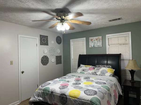 a bedroom with a bed and a chandelier